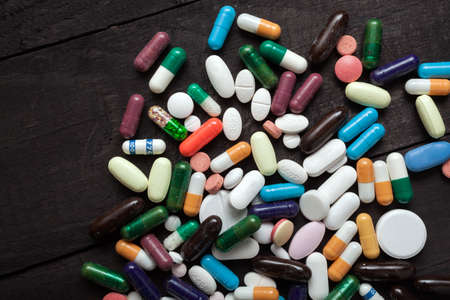 Colorful pills over dark background