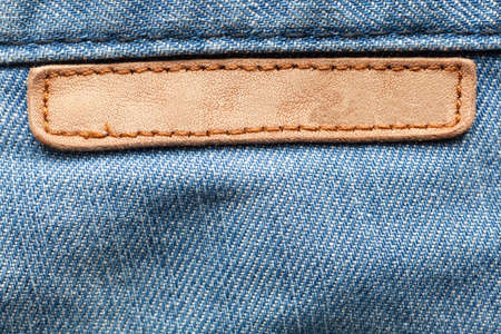 Blank leather jeans label sewed on a blue jeans.