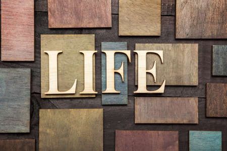 Wooden letters forming word LIFE written on wooden backgroundの写真素材