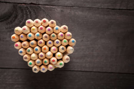 Color pencils on dark wooden backgroundの写真素材