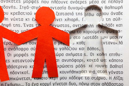 Clipped paper doll within a book with Greek textの写真素材