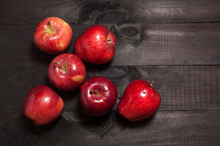 Fresh red apples on wooden black backgroundの写真素材