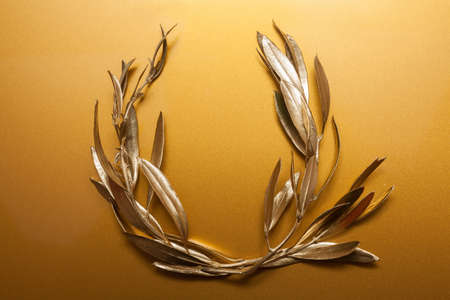 Golden Olive Wreath on golden backgroundの写真素材
