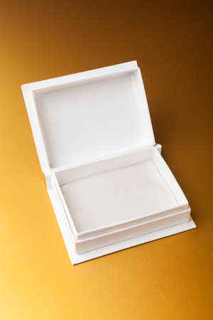 White open box on golden background