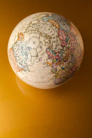 Old fashioned globe on golden backgroundの写真素材