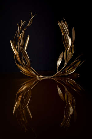 Golden Olive Wreath on dark backgroundの写真素材