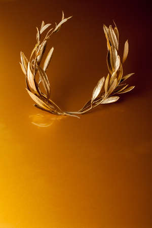 Golden Olive Wreath on golden backgroundの写真素材