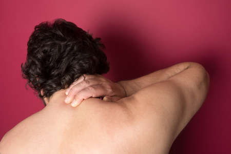 Man suffering from back neck ache, muscle painの写真素材