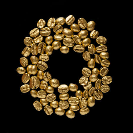 Golden cafe - coffee beans on black backgroundの写真素材