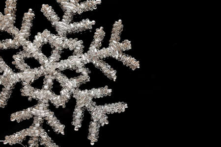 Christmas decoration silver snowflake on a black background

の写真素材