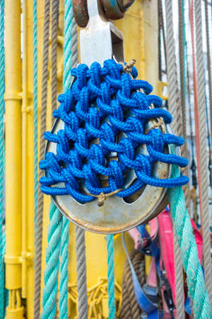 Sea hemp ropes and pulleys on the old nautical vessel.の写真素材