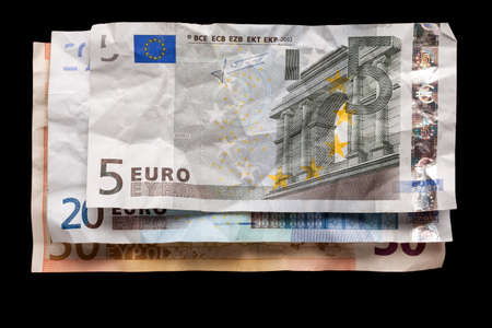 Crumpled euro money on black backgroundの写真素材