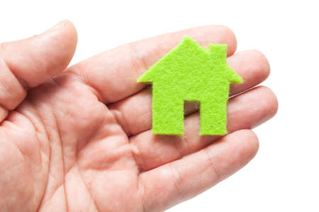 Hand Holding Green Icon House on White Backgroundの写真素材