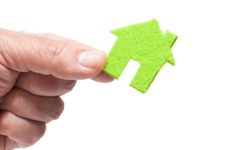 Hand Holding Green Icon House on White Backgroundの写真素材