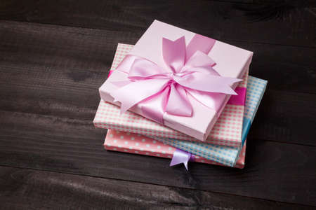 Gift packages tied with ribbons on black backgroundの写真素材
