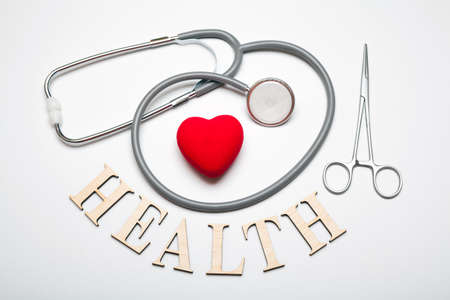 Stethoscope with pills, scissors, heart and the word HEALTH