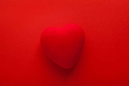 Red heart on red backgroundの写真素材