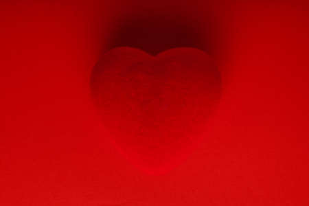 Red heart on red backgroundの写真素材
