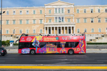 ATHENS, GREECE - MAY 15: Tourist bus the greek Parliament Building situated at the Syntagma Square on May 15, 2014 in Athens, Greeceのeditorial素材