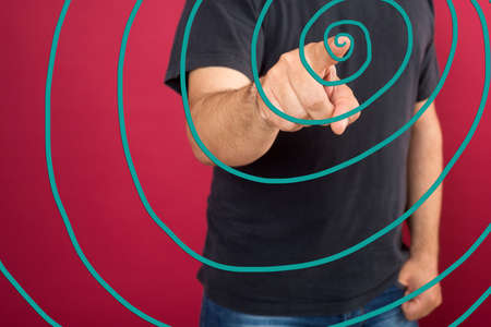 Young casual man pointing something on glass board with marker の写真素材