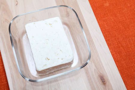 Traditional white Greek cheese named feta on a Wooden Surface の写真素材