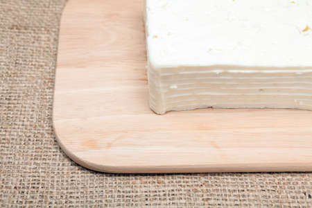 Traditional white Greek cheese named feta on a Wooden Surface 