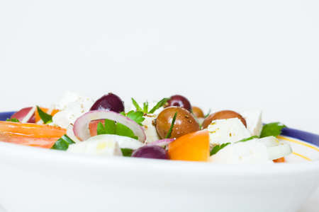 Greek vegetable salad with tomato, onion, cucumber, parsley, olives and feta cheeseの写真素材