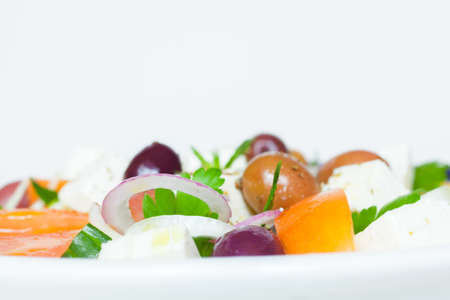 Greek vegetable salad with tomato, onion, cucumber, parsley, olives and feta cheeseの写真素材