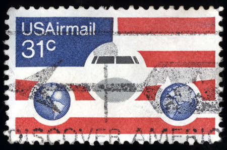 UNITED STATES - CIRCA 1976: stamp printed in United states, shows Plane Globes and flag, circa 1976 のeditorial素材