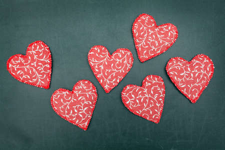 A lot of hearts on dark wooden background 