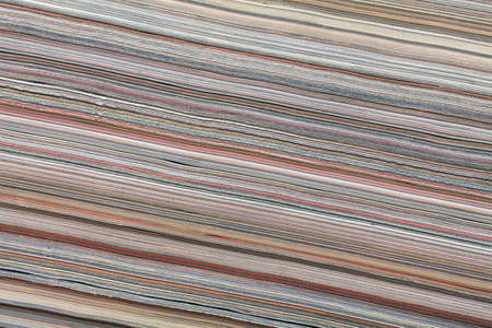 Large stack of magazines piled high texture. 