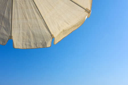 Beach umbrella background against a blue sky の写真素材