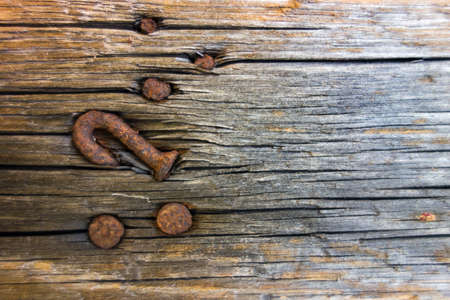 Old dry grained wood with knots and rusty nailsの写真素材