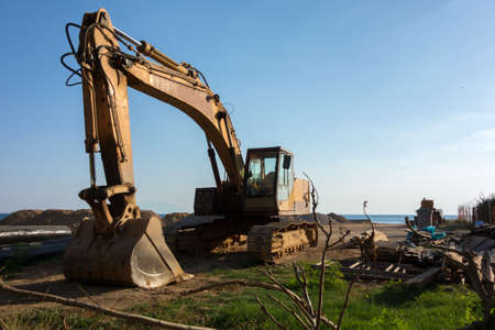 Excavator on road construction site in the afternoonの写真素材