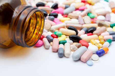 Pills from bottle on the whiteの写真素材