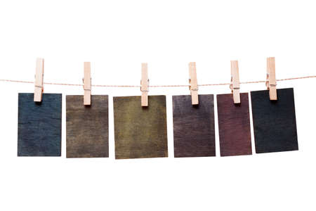 Close up of wooden notes attach to rope with clothes pins on white background の写真素材