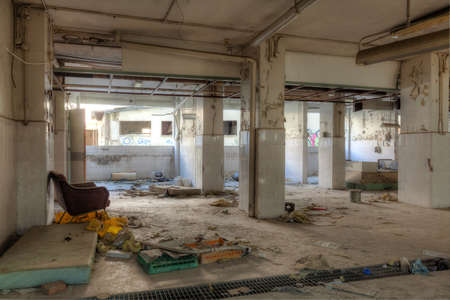 Interior of an abandoned building with rubble and debris. Deserted old hospitalの写真素材