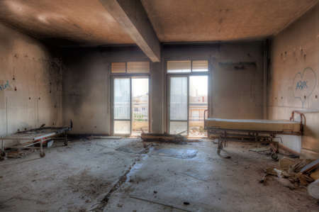 Interior of an abandoned building with rubble and debris. Deserted old hospitalの写真素材
