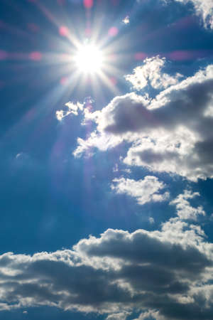 Blue sky with clouds and sun.の写真素材