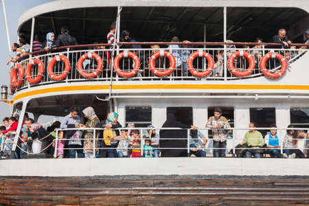 ISTANBUL - OCTOBER 7: People get on board the ship at Eminonu on October 7, 2014 in Istanbul. Nearly 150,000 passengers use ferries daily in Istanbul, due to easy access to two different continents.のeditorial素材