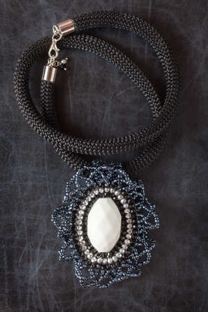 Bead Necklace on a dark surface.の写真素材