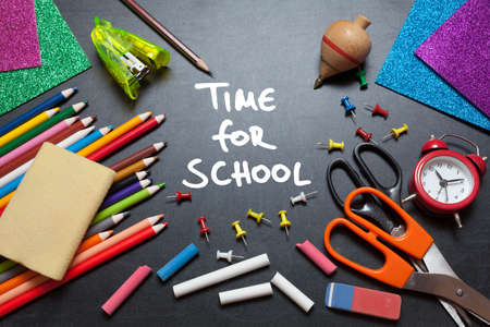 Time for school. School tools around. Blackboard background.の写真素材