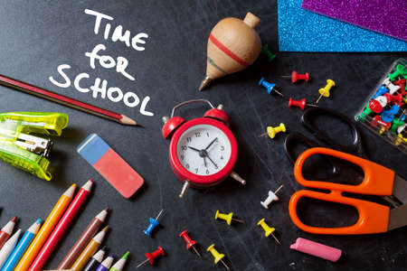 Time for school. School tools around. Blackboard background.の写真素材