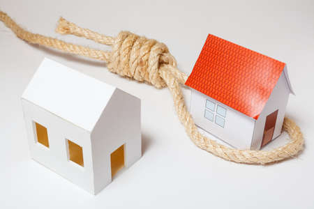 Small house with hangman's noose on white backgroundの写真素材