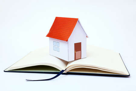 Requirements of the house. Paper house on memorandum blockの写真素材