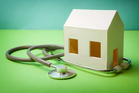 Requirements of the house. Paper house with stethoscope that indicates the health of the house.の写真素材