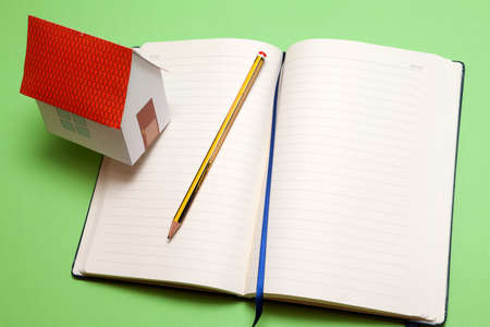 Requirements of the house. Paper house on memorandum blockの写真素材