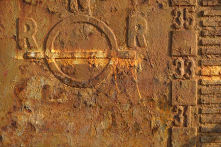 Rusty steal texture of an abandoned tanker boat closeup. Waterline and draft scale measureの写真素材
