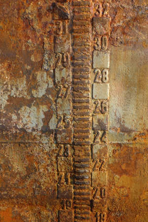 Rusty steal texture of an abandoned tanker boat closeup. Waterline and draft scale measureの写真素材