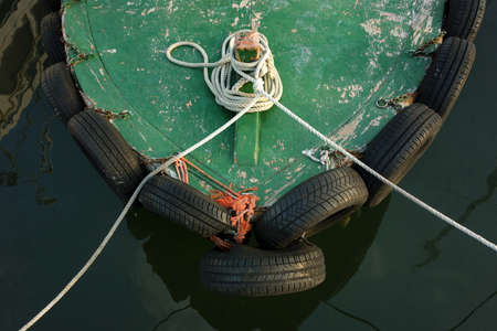 Bow of small fishing boat in a harborの写真素材